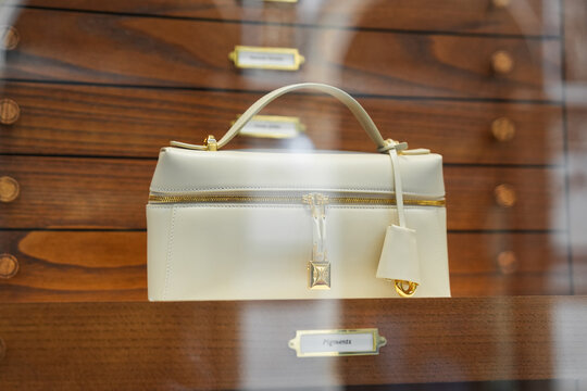 Milan, Italy - August, 14, 2025: Elegant luxury Loro Piana extra L27 handbag displayed on fashionable storefront stand. Bag at boutique fashion display, vitrine of the clothes shop