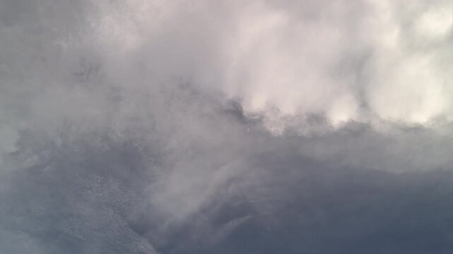 Blue sky with white clouds and the sun. Fast-moving white and gray clouds. Time-lapse photograph of cumulus clouds. Nature time-lapse video in the rainy season. Weather. Sky. Nature.