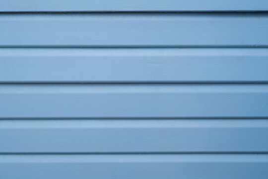 Blue painted horizontal wooden boards with clean repeating lines