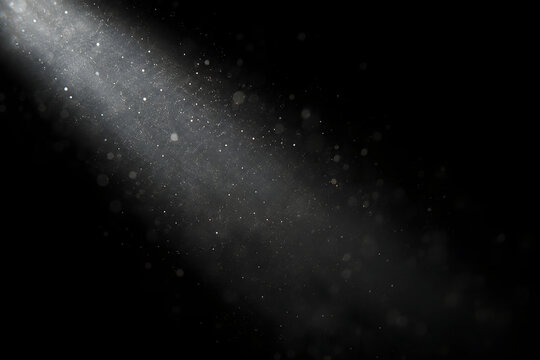 Abstract white dust floating in darkness