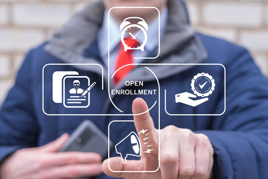Business person using virtual touchscreen presses the text OPEN ENROLLMENT. Concept of open enrollment.