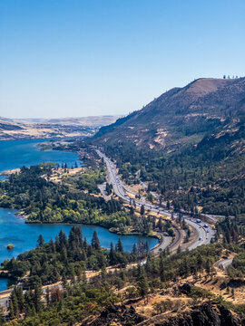 Panoramic view from Rowena Crest Viewpoint over the Columbia River Gorge, with the river, curving highway, forested shoreline, and dry rolling hills in Oregon
