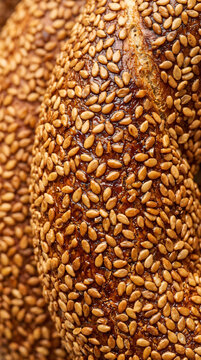 Close up view of traditional Turkish simit bread covered in toasted sesame seeds.