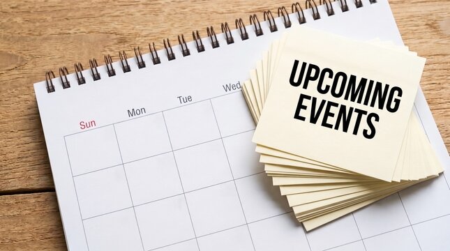 Upcoming events written on sticky notes on a desk calendar