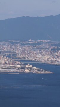 Hiroshima City aerial panoramic view seen from Mount Misen on Miyajima Island, with Seto Inland Sea, Hiroshuma bay and skyline, port and oyster farming rafts, Chugoku, Japan, mountains in background