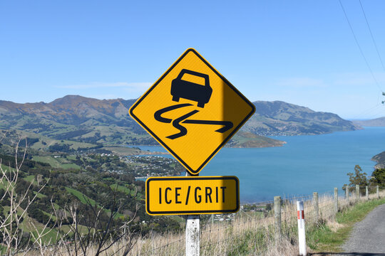 Yellow Ice grit road sign in Akaroa New Zealand for slippery road black ice in winter