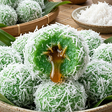 Traditional Indonesian Klepon rice cakes filled with palm sugar and coated in shredded coconut.