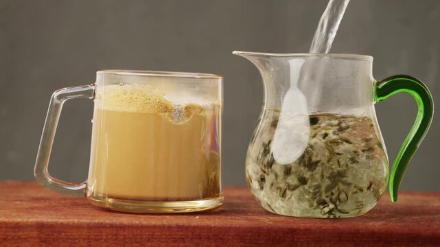 Brewing instant coffee and oriental tea with hot water. A cup of coffee and a cup of tea placed side by side, common hot drinks, two beverages made with hot water.
