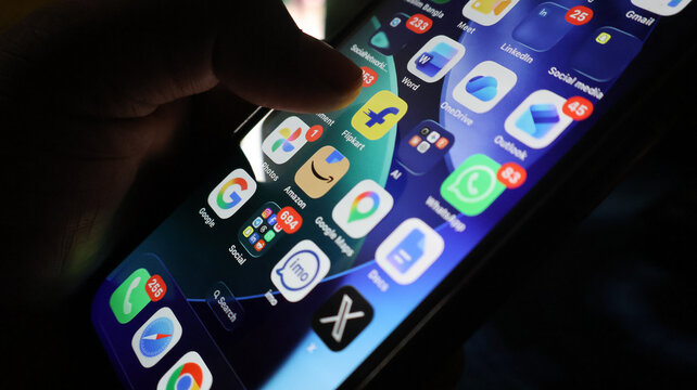 Smartphone screen interface display with multiple mobile application icons and notification badges in dark mode.