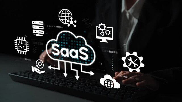 Professional woman typing on keyboard with digital SaaS icons and technology graphics representing software as a service solutions during night work session. Entropy.