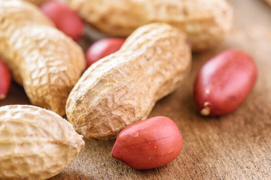Closeup view of fresh peanuts on wooden table
