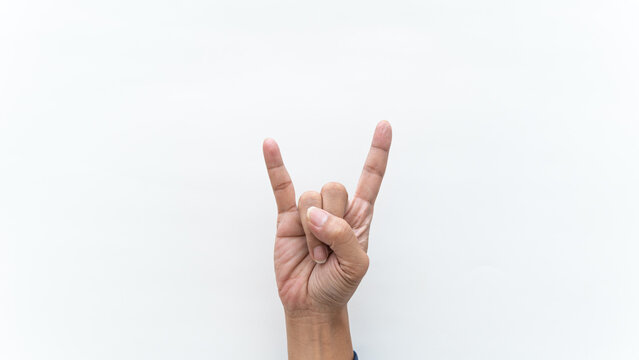 Human hand performing devil horns gesture for rock and heavy metal music isolated on white backdrop