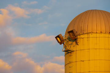 Farm silo with spotlights glowing at golden hour © SNEHIT PHOTO