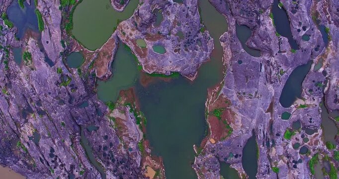 Amazing geological formations shaped by flowing water and sediment along the Mekong River, creating unique holes, pools, and rock patterns at Sam Phan Bok.