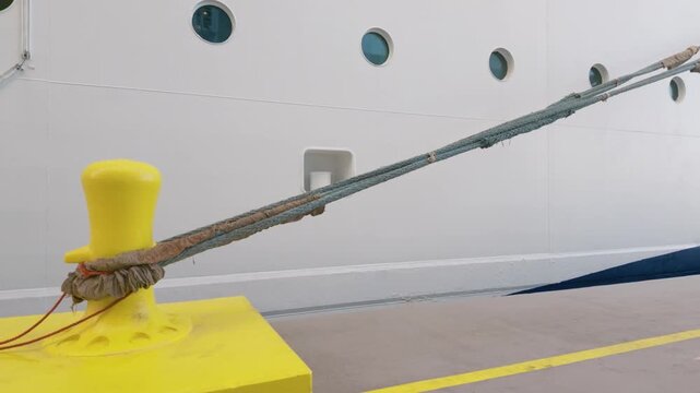 Large Cruise Ship Moored to Yellow Dock Cleat with Heavy Marine Rope