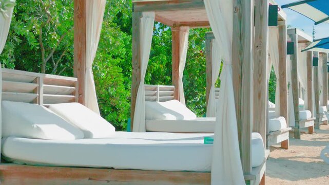 Luxury Beach Cabanas with White Daybeds and Privacy Curtains