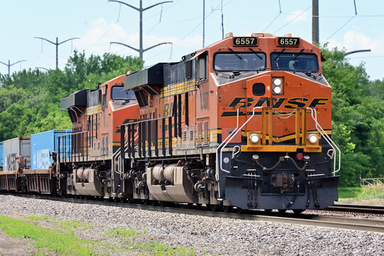 An eastbound  Burlington Northern Santa Fe stack train travels through a small community west of Chicago on its journedy from Denver.