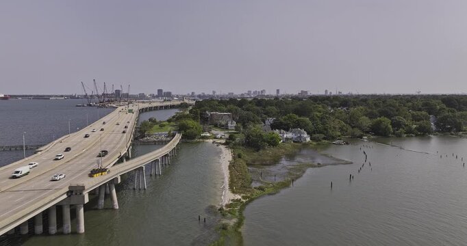 Portsmouth Virginia Aerial v1 low flyover Hull Creek along the freeway bridge towards Port Norfolk neighborhood capturing marine terminal and cityscape - Shot with 5k Camera - Sept 30th 2023