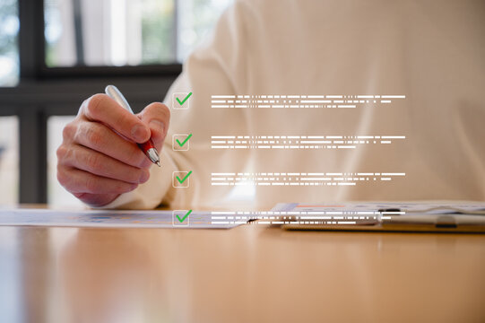 Businessman using pen, completing checklist on document in data system Report HR technology Concept, A checklist for policy implementation featuring a standard and official approved documents