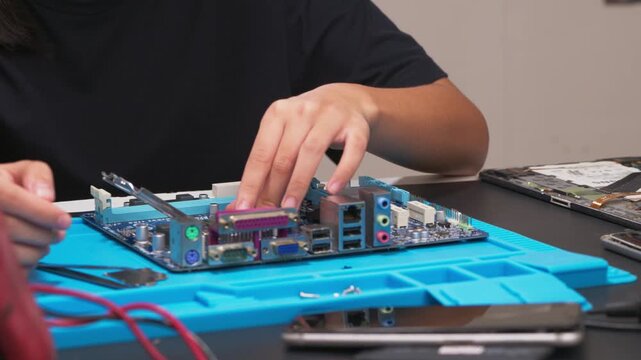 hand installing a central processing unit CPU microprocessor chip into computer motherboard socket as a conceptual metaphor for AI hardware technology computer engineering data 
