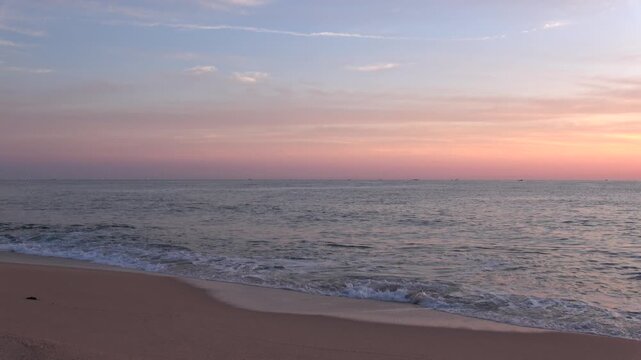 A tranquil long take video capturing peaceful ocean waves gently washing ashore during dawn in Gangneung, South Korea on June 27, 2026, featuring authentic ambient ASMR sounds.