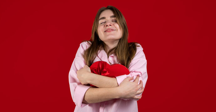 Happy, cheerful in love woman with red gift box. St Valentine's copy space banner