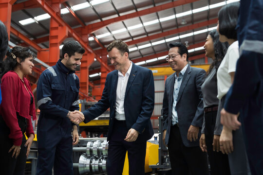 Manager, worker and factory. Group of corporate colleagues, manager and engineer, technician meeting, discuss conference together in factory workplace. Teamwork corporate worker factory successful