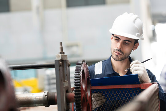 Male engineer, factory and maintenance machine. Industrial operator inspecting industry machine manufacturing factory. Technician quality control, inspect, checking in factory