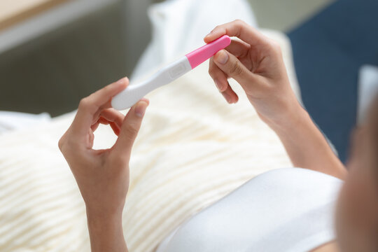Woman holding pregnancy test kit at home, close up concept of pregnancy check, fertility awareness, family planning, reproductive health, prenatal decision, personal maternity journey.