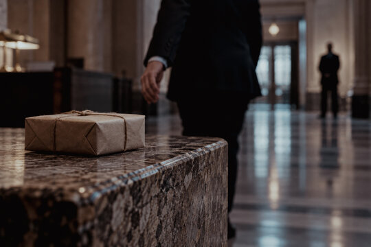 Brown paper parcel on a marble table in a hallway