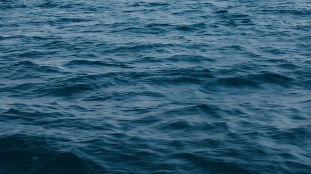 Top view of deep blue sea water surface with small ripples, aerial drone shot of turquoise ocean texture at island , abstract nature background	
