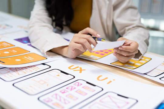 UX UI designer developing user experience and interface mockups for a mobile application, working on web design and app development.