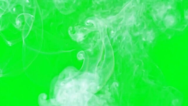 Wisps of steam rising gracefully on green screen