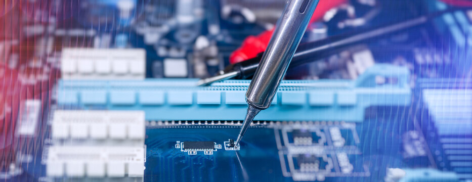 Precision Soldering Iron Repairing Electronic Circuit Board with Microchip Components in Technology Workshop