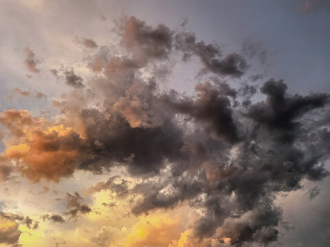 Dark Storm Clouds Glowing In Golden Sunset Light