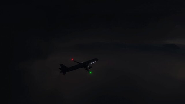 Commercial Passenger Airplane Flying Through Dark Night Thunderstorm