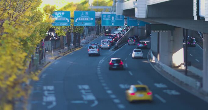 A cityscape of miniature traffic jam near the yellow gingko street under the