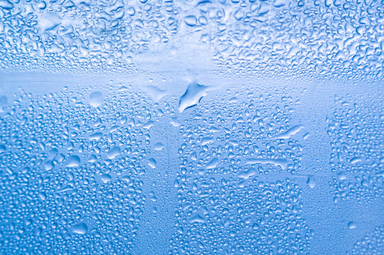 Water condensation droplets on blue background abstract texture