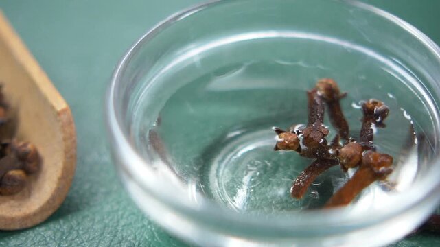 Cloves soaking in water for preparation and use in cooking