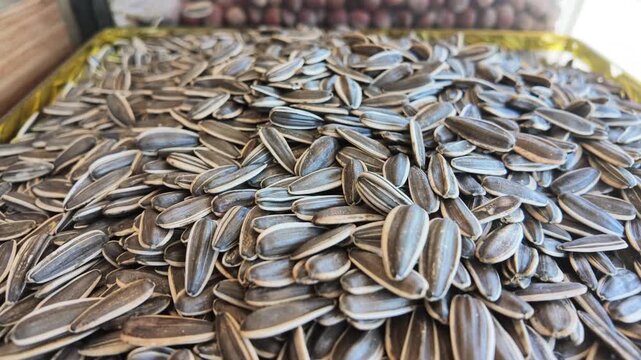 Bulk quantities of sunflower seeds available for purchase at a market