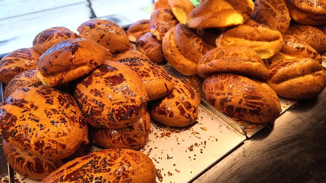 Freshly baked bread on display in a bakery during daytime