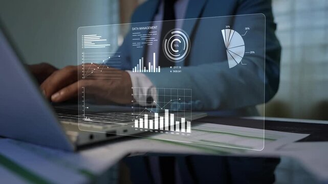 Business professional using a laptop at a desk with a transparent data dashboard overlay, showing digital analytics, finance, and modern workplace technology.