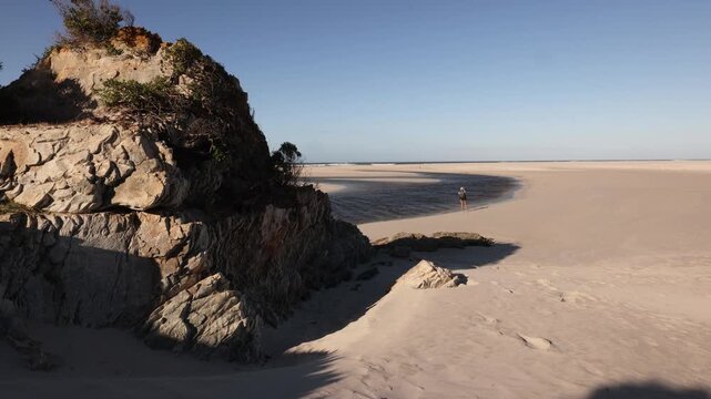 female photographer a edge of Lagoon emptying into Atlantic Ocean, Hermanus, South Africa 