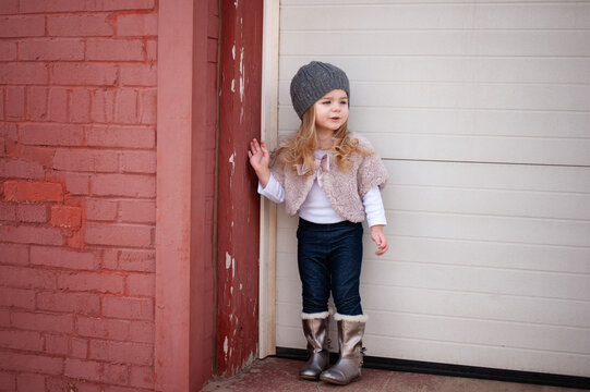 Fashionable little girl in fall clothes outdoors