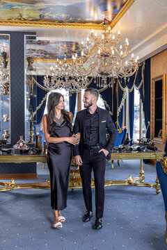 Elegant well dressed couple walking in luxurious romantic restaurant