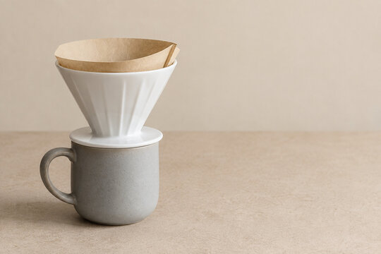 Paper coffee filter seated in a ceramic pour over dripper