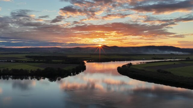 Aerial footage of the Clarence River and farmland in the warm evening light on Palmers Island, Yamba, New South Wales.