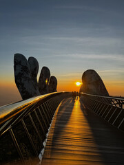 Beautiful sunset view on Golden Bridge held by giant stone hands at Ba Na Hills, Da Nang, Vietnam © Thornapat