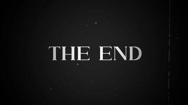 The end vintage old film text animation with noise and grain on dark background.