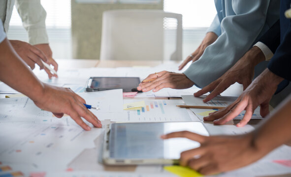 Business hands creating project financial charts and data mind map with colorful sticky notes